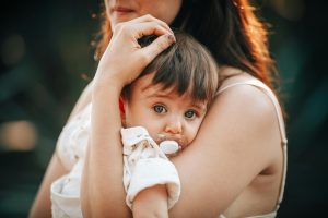 pexels-photo-27175926-27175926 A touching close-up of a mother lovingly holding her baby outdoors.