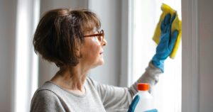 Senior woman cleaning a window